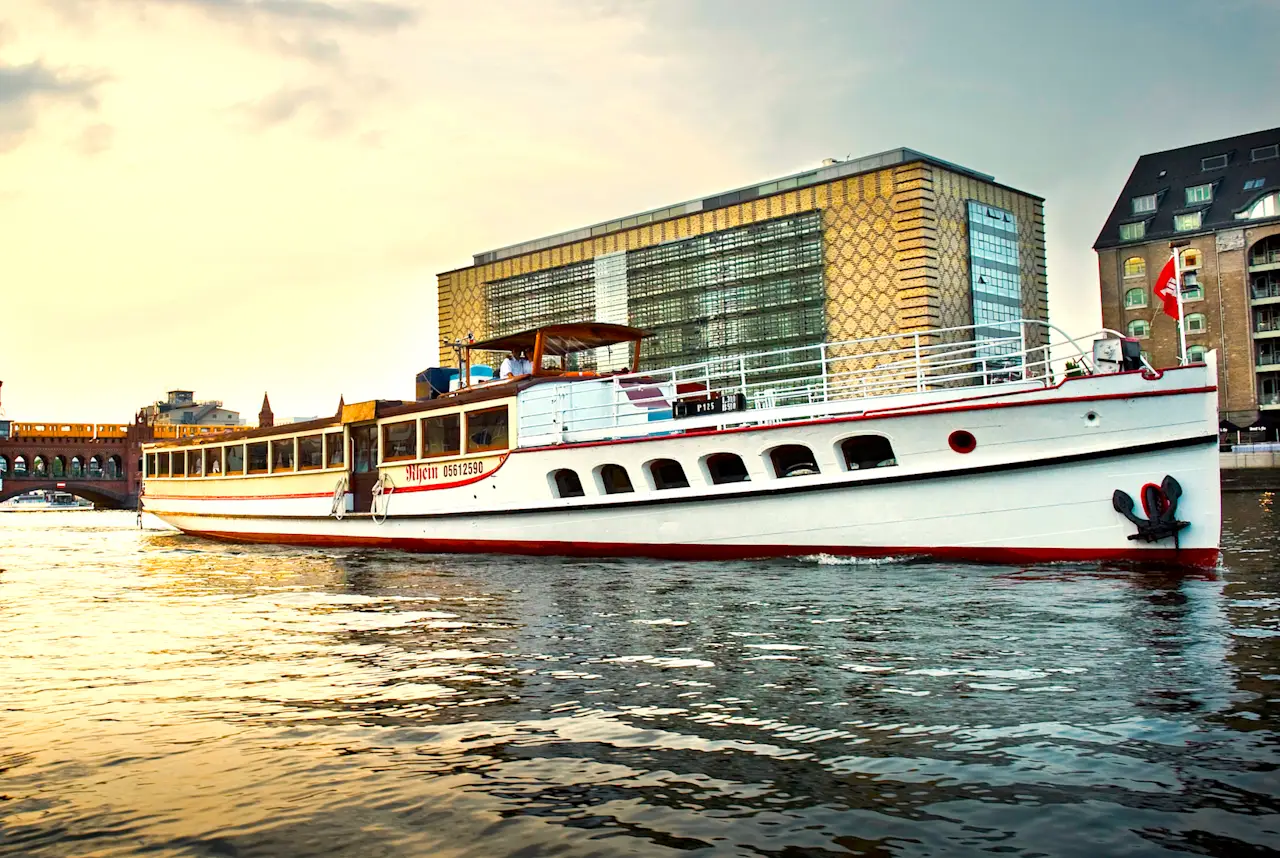 The ship "Rhein" at sunset on the river Spree in front of the Oberbaum Bridge