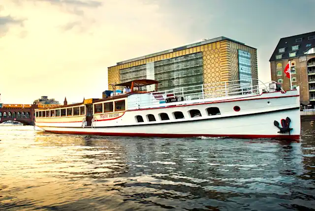 The ship "Rhein" at sunset on the river Spree in front of the Oberbaum Bridge