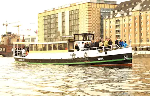 Boat Vera on a trip in front of the Oberbaum Bridge in Friedrichshain