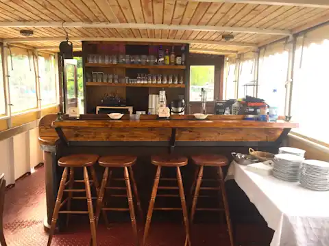 Bar, counter and stool made of wood on the party ship Vera